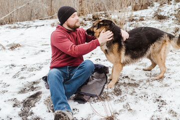 Owner man having fun with best friend german shepherd.