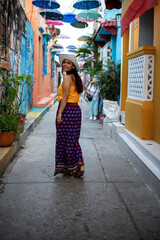Beautiful Colombian woman with colorful outfit in the old city of Cartagena, Colombia