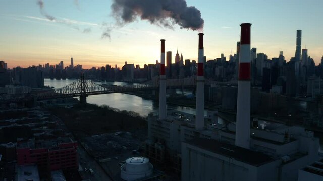 alt sunset flying towards LIC power plant and tilting up at smoke