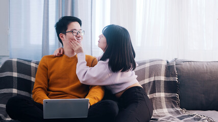 Young woman distracting her boyfriend from working. Remote work disadvantages. High quality photo