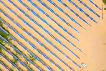 Aerial view of flooded solar power station with dirty river water in rain season.