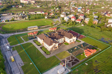 Fototapeta na wymiar Aerial view of new prescool building in residential rural area.