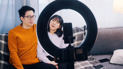 Obraz na płótnie Canvas Asian couple, recording video with phone camera. Influencers streaming on social media. High quality photo