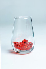 Valentine's Day. Small red glass hearts in a glass.