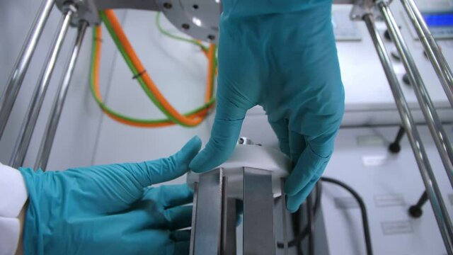 Worker removes part of machine tool in chemical laboratory