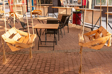 Wooden swing chair in the coffee shop for two person