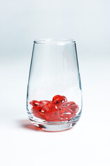 Valentine's Day. Small red glass hearts in a glass.