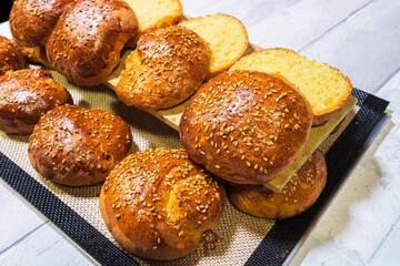 freshly baked buns cut to make pulled pork hamburger