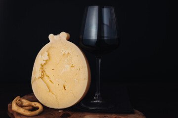 Delicious Caciocavallo cheese with red wine and taralli