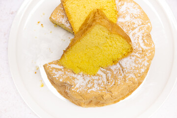 Homemade Savoie cake on a pretty white porcelain dish