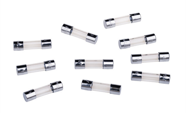 Small glass electrical fuses with fusible metal wire isolated on white background. Set of electronic circuit protectors. Safety device for overcurrent protection in transparent tube between terminals.