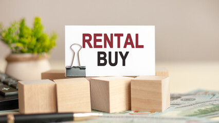 piece of paper with the text: rental buy. Business and finance concept.