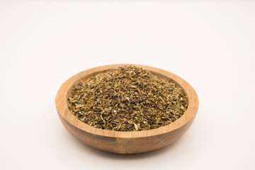 Crushed and dried basil leaves.