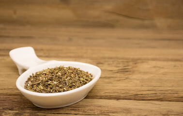 Crushed and dried basil leaves.