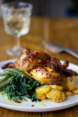 Roasted poussin with potatoes, mashed swede, green beans and creamy spinach