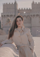 Gorgeous blue eyed brunette hair young leaning on the bridge of Valencia posing and looking at the...