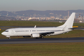 Fototapeta na wymiar Withe Boeing 737-800 airplane on the runway