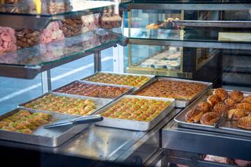 Cookies and sweets are in the window of a pastry shop