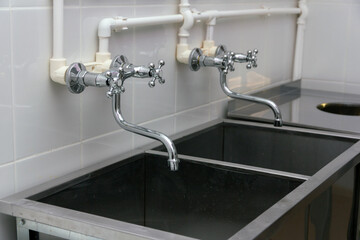 Sink for washing the post in the kitchen in a cafe or restaurant. The kitchen of a public catering establishment. Professional dishwashing.