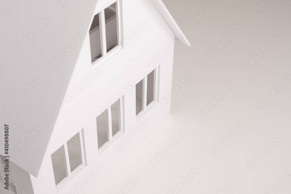 Poster building layout close-up. miniature model of a two-story house. cottage with a triangular roof. thre