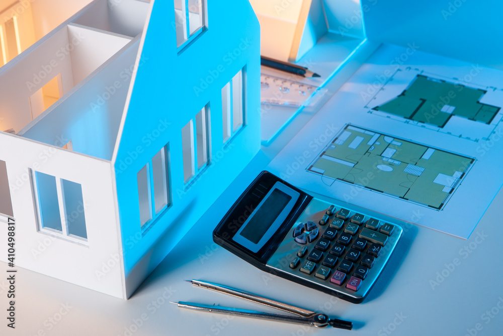 Poster calculator and architectural drawings on table. personal belongings of architect. compass and constr