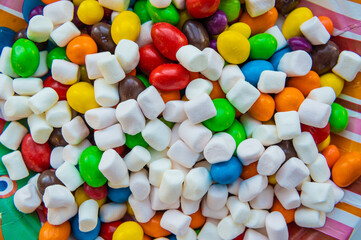Mixed marshmallow candies with sugar, banana jelly candies, background with sweets, marshmallow figure, jelly rings