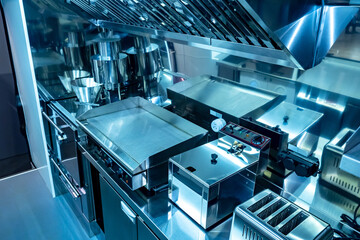 Small kitchen restaurant. Equipment in the restaurant is made of stainless steel. Concept of a mobile cafe. Restaurant kitchen on wheels with industrial equipment. Equipment for cafe on wheels