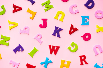 English alphabet letters on pink background pattern.