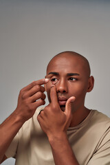 Male inserting a lens inside an eye