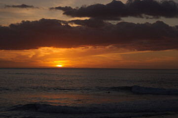 Fototapeta na wymiar Landscape of a sunset with clouds over the sea near an island