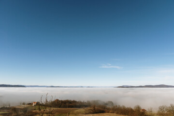 Dense fog over rural fields in West Serbia