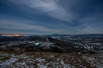 Panorama of a winter village at night in the mountains
