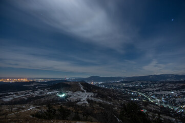 Panorama of a winter village at night in the mountains