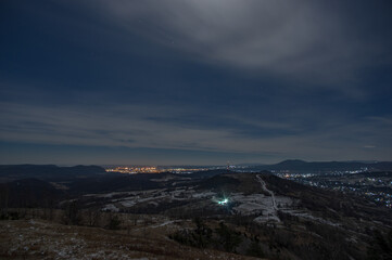 Panorama of a winter village at night in the mountains