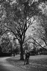 The guy with the girl lovers walk in the park autumn