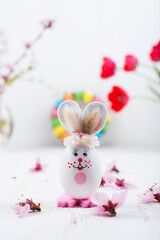 Easter bunny with eggs on a white wooden background