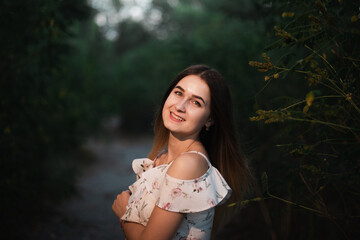 Naklejka premium Blonde girl in summer light dress in summer outdoors