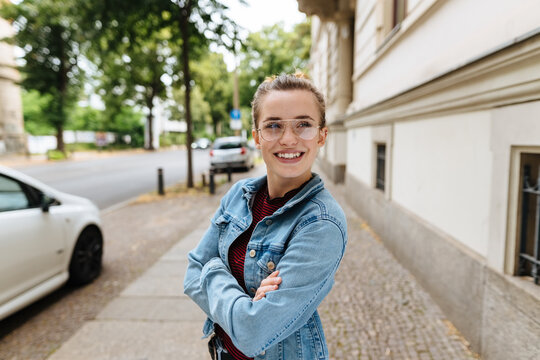 Smiling trendy young woman in denim