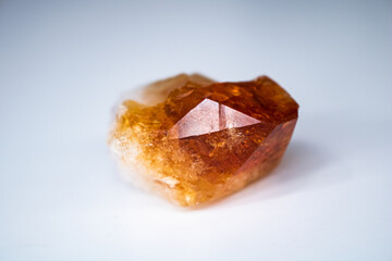 Citrine quartz gemstone crystal isolated on background from front three-quarters view