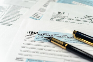 1040 Tax Return Form with a Pen. United States federal income tax return IRS 1040 documents