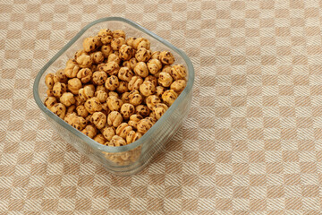 Some Turkish double roasted chickpeas (leblebi) in a square glass bowl