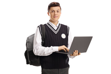 Teenage student in a school uniform holding a laptop computer