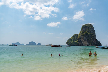 Vintage and retro toning of tropical beach with blue sky and clear sea which including of a wooden umbrella and chair in sunrise time with vintage retro tone. Vacation time as concept.	
