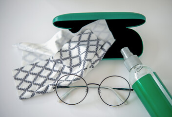 Top view a set of eyes glasses cleaning accessories.  Eyes glasses with cleaning spray, micro fiber...