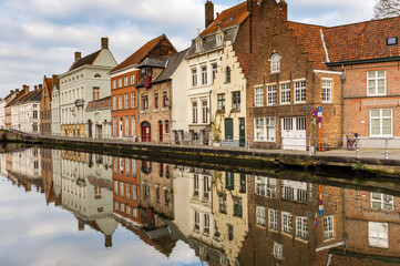 Fototapeta na wymiar Reflections of typical Bruges house terrace in the canal