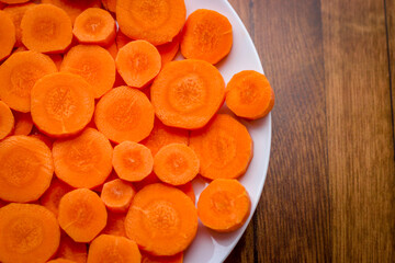Delicious food background. Raw carrots cut into mugs