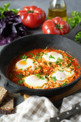 Tasty and Healthy Shakshuka in a Frying Pan. Eggs Poached in Spicy Tomato Pepper Sauce. High quality photo