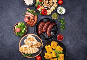 Grilled sausages, meat, and vegetables.