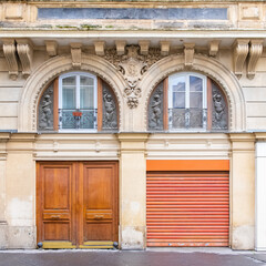 Paris, an ancient wooden door, typical building in the center
