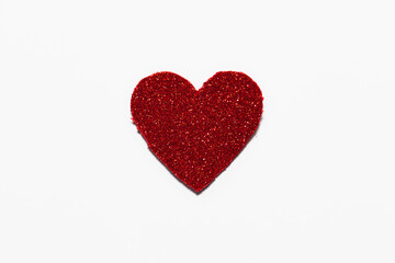 Red glitter heart on white background